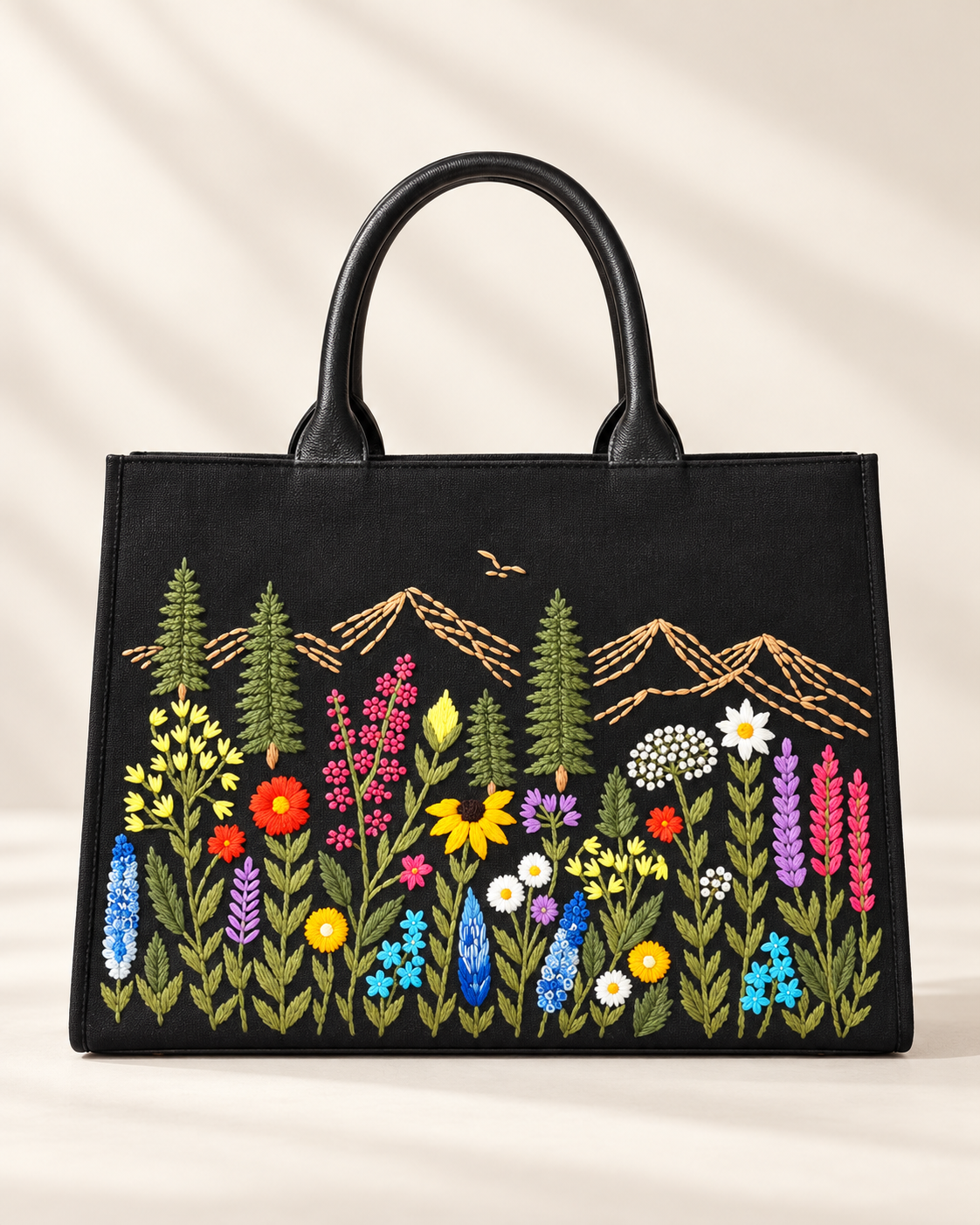 Black Meadow Structured handbag with hand-embroidered wildflowers and mountains, front view